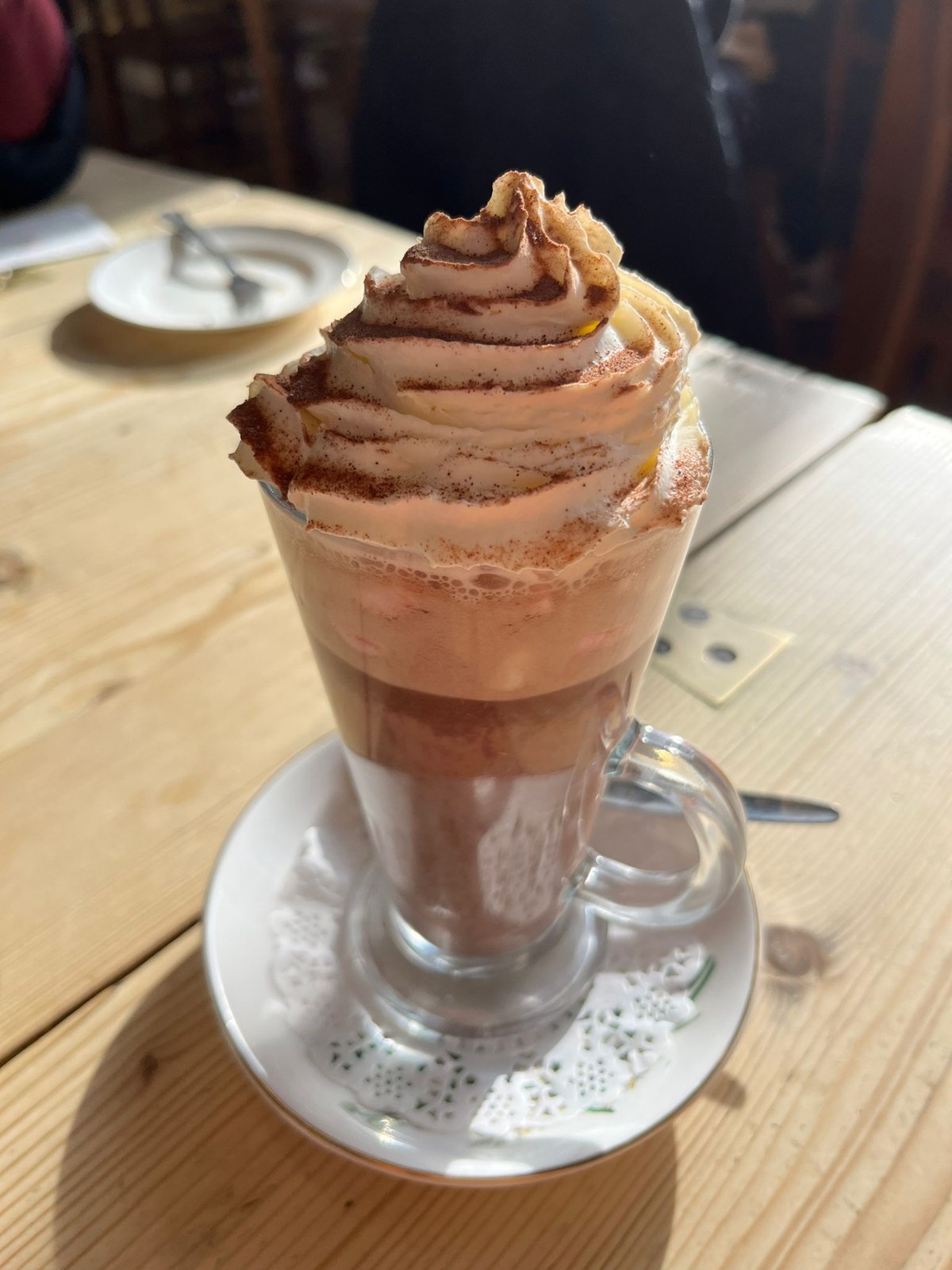 A chocolate drink in a glass on a café table