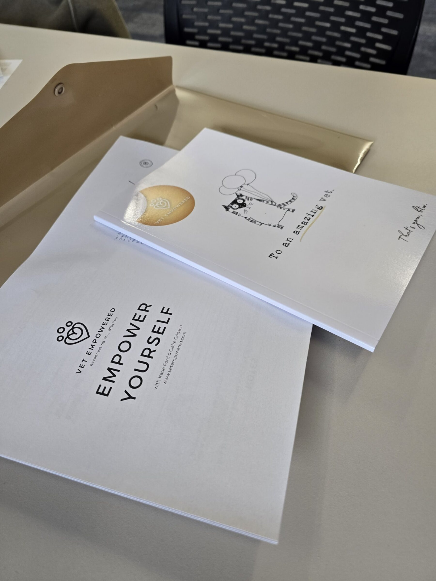 Vet Empowered course workbooks on a table