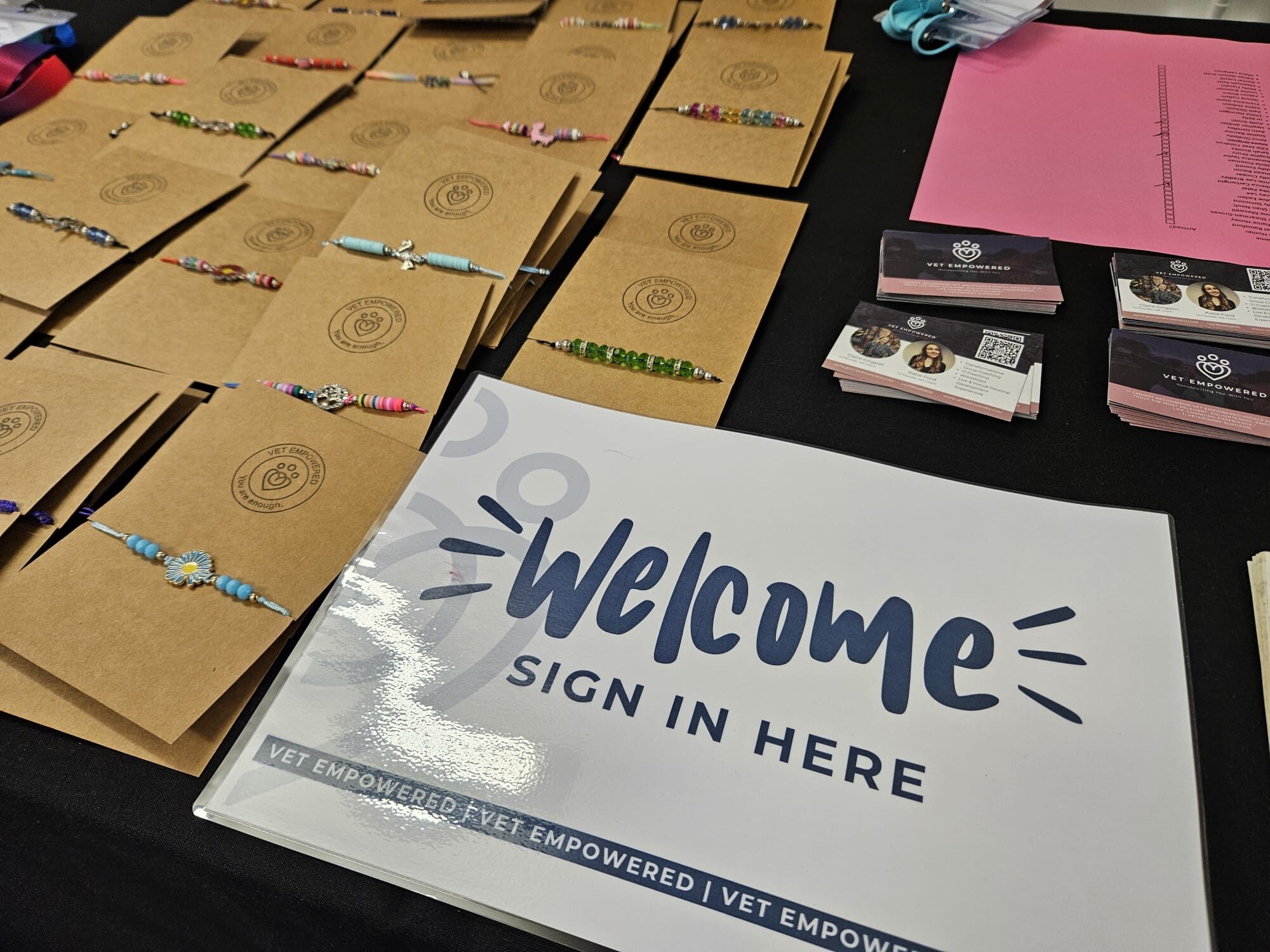 A Vet Empowered welcome table with You are enough bracelets